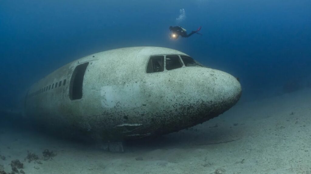 Airplane wreck diving underwater. Submechanophobia.