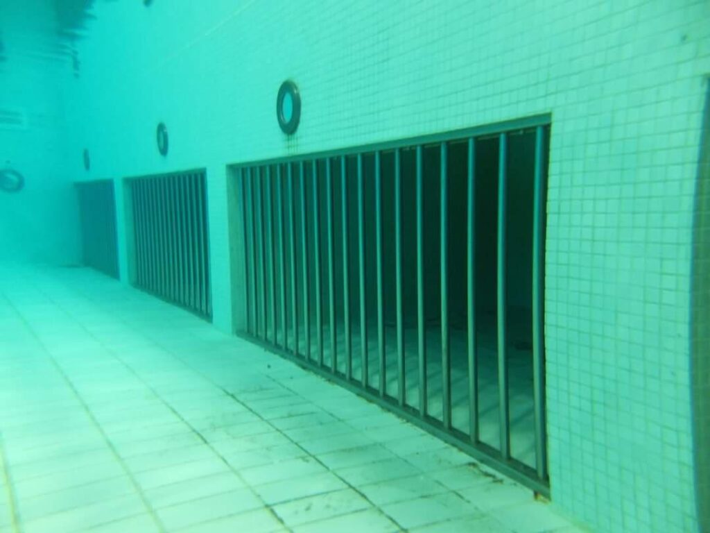 Underwater photo of bars of a wave machine in a pool. Submechanophobia photo.