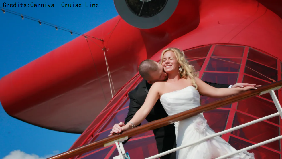 wedding couple standing in front of funnel of carnival cruise ship